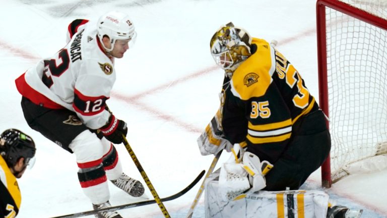 Boston Bruins goaltender Linus Ullmark makes a stick save on Ottawa Senators' Alex DeBrincat during the second period of a game, March 21, 2023. (AP Photo/Charles Krupa)