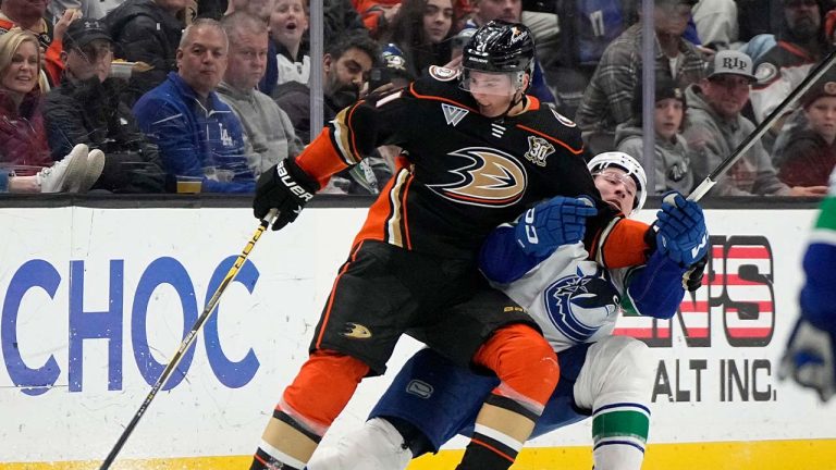 Anaheim Ducks center Isac Lundestrom, left, and Vancouver Canucks right wing Brock Boeser collide during the third period of an NHL hockey game Sunday, March 3, 2024, in Anaheim, Calif. (Mark J. Terrill/AP)