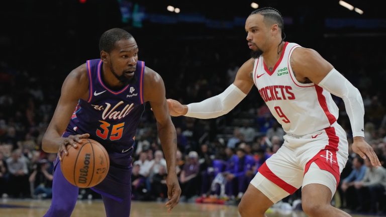 Phoenix Suns forward Kevin Durant (35) drives on Houston Rockets forward Dillon Brooks during the first half of an NBA basketball game, Thursday, Feb. 29, 2024, in Phoenix. (AP Photo/Rick Scuteri)