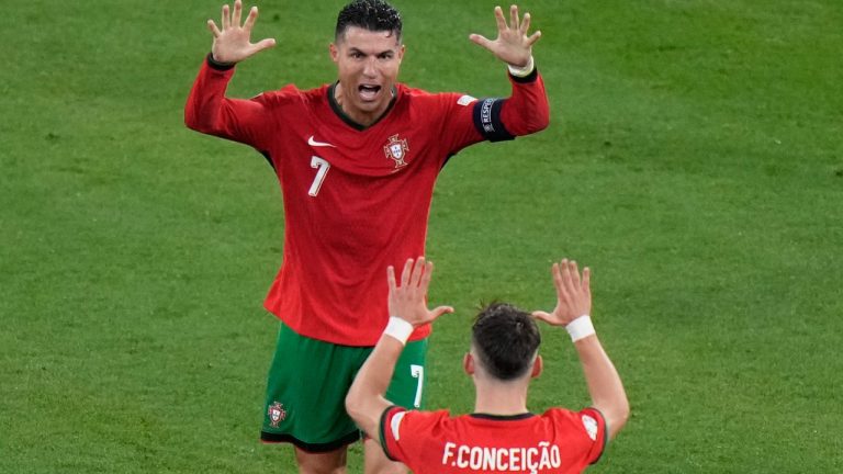 Portugal's Cristiano Ronaldo (7) and Francisco Conceicao celebrate after a Group F match between Portugal and Czech Republic at the Euro 2024 soccer tournament in Leipzig, Germany, Tuesday, June 18, 2024. (AP Photo/Sergei Grits)