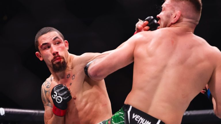 Robert Whittaker punches Dricus Du Plessis during a middleweight mixed martial arts bout at UFC 290 in Las Vegas. (Wade Vandervort/Las Vegas Sun via AP)