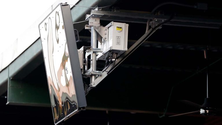 A radar device is seen on the roof behind home plate at PeoplesBank Park during the third inning of an Atlantic League All-Star minor league baseball game in York, Pa. Baseball's top minor leagues are switching to a challenge system full-time for their test of robot umpires. Major League Baseball has been experimenting with the automated ball-strike system in the minor leagues since 2019. (Julio Cortez/AP)