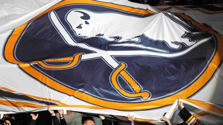 Boston Bruins fans assist in passing around a large Buffalo Sabres logo banner before the first period of an NHL hockey game in Buffalo, N.Y. on Saturday, Jan. 1, 2011. (Don Heupel/AP)