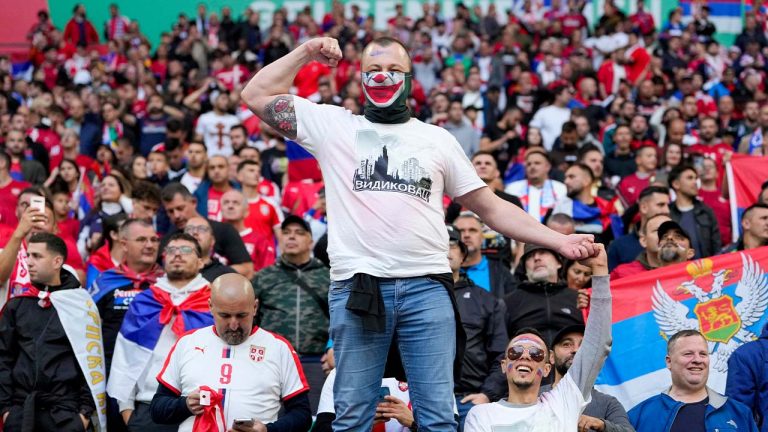 A Serbian fan wearing a mask strikes a pose ahead of a Group C match between Serbia and England at the Euro 2024 soccer tournament in Gelsenkirchen, Germany, Sunday, June 16, 2024. (Andreea Alexandru/AP)