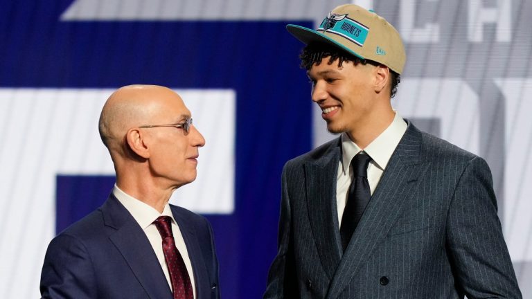 Tidjane Salaun greets NBA commissioner Adam Silver after being selected by the Charlotte Hornets with the sixth overall pick of NBA draft, June 26, 2024. (AP Photo/Julia Nikhinson)