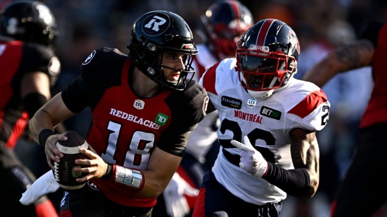 Montreal Alouettes linebacker Tyrice Beverette (26) looks to tackle Ottawa Redblacks quarterback Dustin Crum (18) during the first half of a game, Sept. 30, 2023. (The Canadian Press/Justin Tang)