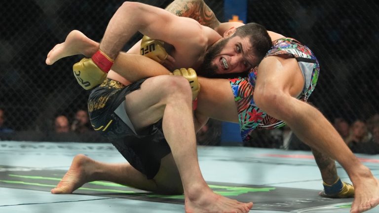 Russia's Islam Makhachev works a takedown against Dustin Poirier during a lightweight title bout at the UFC 302. (Frank Franklin II/AP)