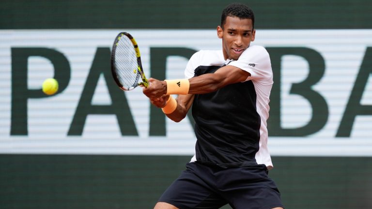 Canada's Felix Auger-Aliassime plays a shot against Spain's Carlos Alcaraz during their fourth round match of the French Open tennis tournament at the Roland Garros stadium in Paris, Sunday, June 2, 2024. (Thibault Camus/AP)