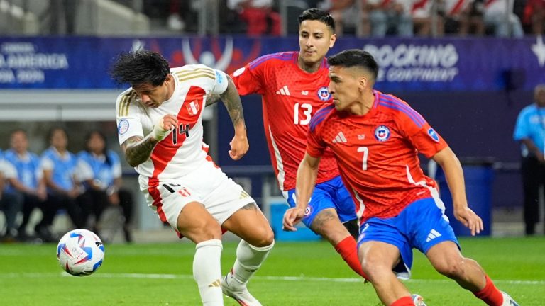 Peru's Gianluca Lapadula, left, and Chile's Marcelino Nunez battle for the ball during a Copa America Group A soccer match in Arlington, Texas, Friday, June 21, 2024. (Julio Cortez/AP Photo)