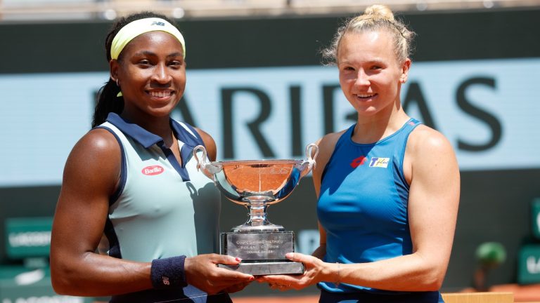 Coco Gauff of the U.S., left, and Katerina Siniakova of the Czech Republic pose with the trophy as they won the women's doubles final match of the French Open tennis tournament against Italy's Sara Errani and Jasmine Paolini at the Roland Garros stadium in Paris, Sunday, June 9, 2024. (Jean-Francois Badias/AP)