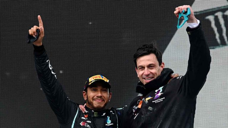 Mercedes driver Lewis Hamilton of Britain and Mercedes team principal Toto Wolff, right, celebrate after Hamilton won the race and his seventh world championship at the Formula One Turkish Grand Prix at the Istanbul Park. (Ozan Kose/AP)