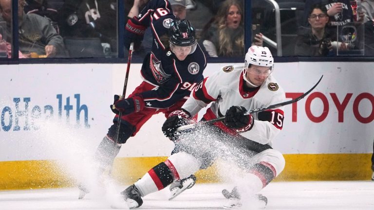 Columbus Blue Jackets centre Kent Johnson (91) and Ottawa Senators centre Matthew Highmore (15) chase the puck during the third period of an NHL hockey game Friday, Dec. 1, 2023, in Columbus, Ohio. (Sue Ogrocki/AP)