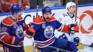 Edmonton Oilers' Zach Hyman (18) celebrates his goal with teammate Ryan Nugent-Hopkins (93) as Florida Panthers' Gustav Forsling (42) looks on during the second period of Game 6 of the NHL hockey Stanley Cup final in Edmonton, Friday, June 21, 2024. (Jeff McIntosh/THE CANADIAN PRESS)