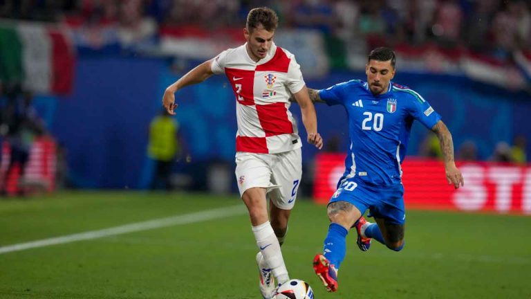 Croatia's Josip Stanisic, left, vies for the ball with Italy's Mattia Zaccagni during a Group B match between Croatia and Italy at the Euro 2024 soccer tournament in Leipzig, Germany. (Sunday Alamba/AP)