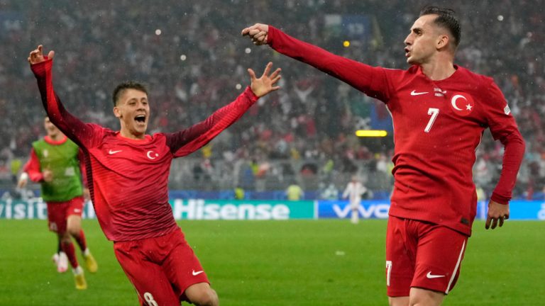 Turkey's Kerem Akturkoglu, right, celebrates with his teammate Arda Guler after scoring his side's third goal during a Group F match between Turkey and Georgia at the Euro 2024 soccer tournament in Dortmund, Germany, Tuesday, June 18, 2024. (Alessandra Tarantino/AP)