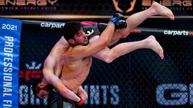 Joilton Lutterbach lifts Clay Collard during a Professional Fighters League mixed martial arts bout in Atlantic City, N.J., Thursday, June 10, 2021. (Matt Rourke/AP)