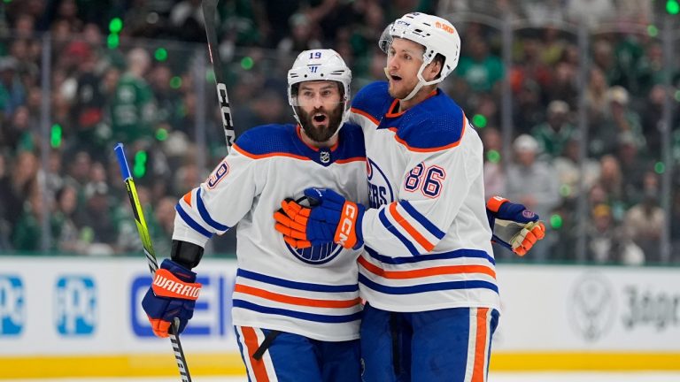 Edmonton Oilers' Adam Henrique (19) and Philip Broberg (86) celebrate after Broberg scored against the Dallas Stars during the second period of Game 5 of the Western Conference finals in the NHL hockey Stanley Cup playoffs Friday, May 31, 2024, in Dallas. (Julio Cortez/AP Photo)