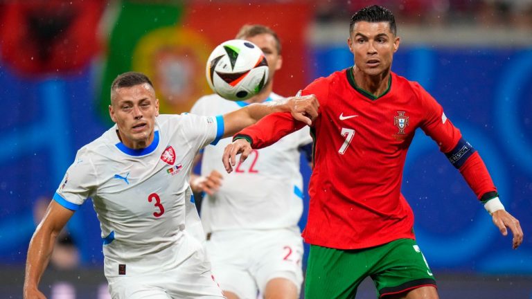 Portugal's Cristiano Ronaldo, right, duels for the ball with Czech Republic's Tomas Holes during a Group F match between Portugal and Czech Republic at the Euro 2024 soccer tournament in Leipzig, Germany, Tuesday, June 18, 2024. (Petr Josek/AP)