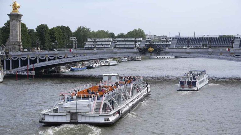 Tourists barges pass under the Alexandre III bridge. (Chistophe Ena/AP)
