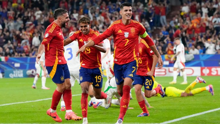 Spain's Alvaro Morata (7) Lamine Yamal (19) and Dani Carvajal, left, celebrate after an own goal by Italy's Riccardo Calafiori during a Group B match between Spain and Italy at the Euro 2024 soccer tournament in Gelsenkirchen, Germany, Thursday, June 20, 2024. (Martin Meissner/AP Photo)