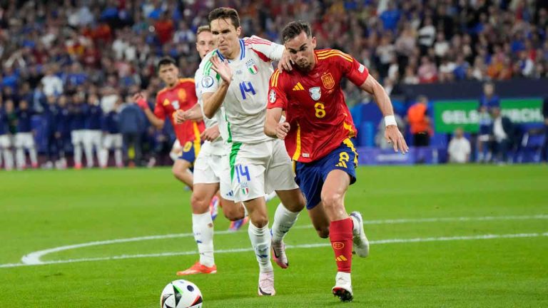 Spain's Fabian Ruiz, right, is defended by Italy's Federico Chiesa during a Group B match between Spain and Italy at the Euro 2024 soccer tournament in Gelsenkirchen, Germany. (Martin Meissner/AP)