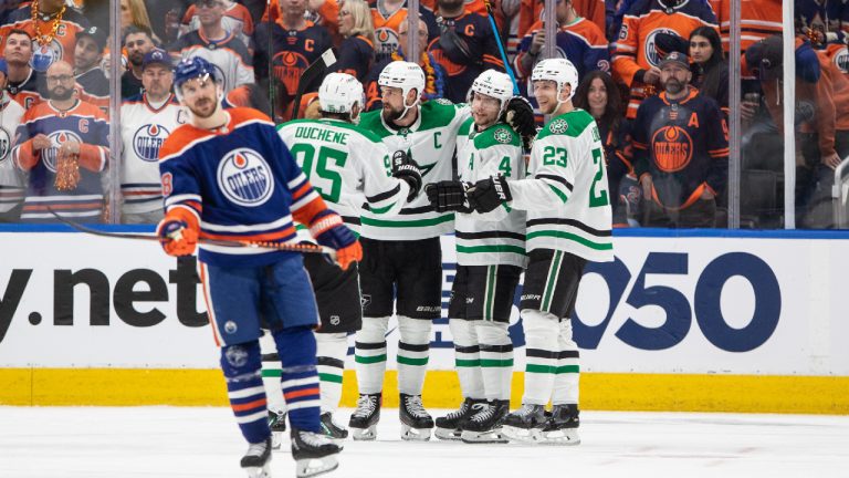 Dallas Stars Matt Duchene (95), Jamie Benn (14), Miro Heiskanen (4) and Esa Lindell (23) celebrate a goal as Edmonton Oilers' Zach Hyman (18) skates past during third period third-round NHL playoff action in Edmonton on Monday May 27, 2024. (Jason Franson/CP)