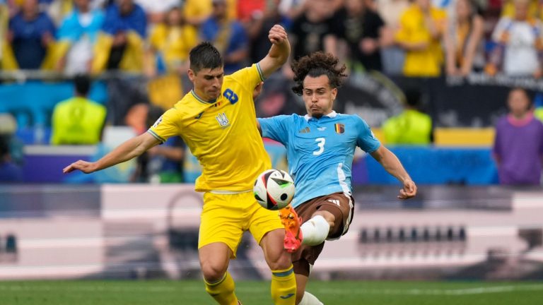 Belgium's Arthur Theate, right, fights for the ball with Ukraine's Ruslan Malinovskyi during a Group E match between Ukraine and Belgium at the Euro 2024 soccer tournament in Stuttgart, Germany, Wednesday, June 26, 2024. (Matthias Schrader/AP Photo)