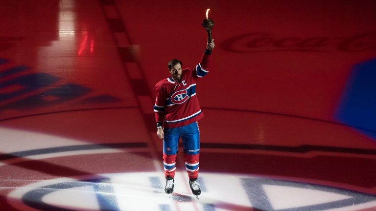 Montreal Canadiens captain Shea Weber holds a flame during a ceremony prior to a NHL hockey game against the Detroit Red Wings in Montreal, Thursday, October 10, 2019. (Graham Hughes/CP)