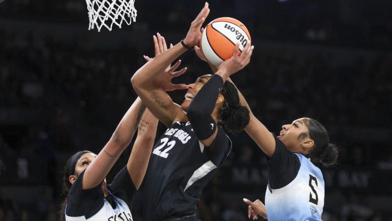 Las Vegas Aces centre A'ja Wilson (22) shoots while Chicago Sky centre Kamilla Cardoso (10) and forward Angel Reese (5) defend during the first half of a WNBA basketball game on Tuesday, July 16, 2024, in Las Vegas. (Ellen Schmidt/Las Vegas Review-Journal via AP)