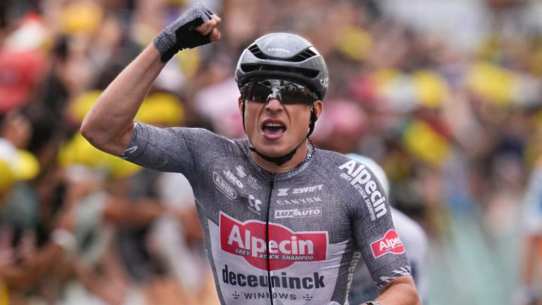 Belgium's Jasper Philipsen celebrates as he crosses the finish line to win the thirteenth stage of the Tour de France cycling race over 165.3 kilometres (102.7 miles) with start in Agen and finish Pau, France, Friday, July 12, 2024. (Daniel Cole/AP)