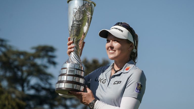 Brooke Henderson, of Canada, celebrates with her trophy after winning the Evian Championship women's golf tournament in Evian, eastern France, Sunday, July 24, 2022. (Laurent Cipriani/AP) 