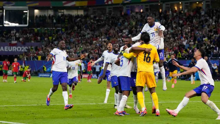 France players celebrate after penalty shootout against Portugal during a quarter final match at the Euro 2024 soccer tournament in Hamburg, Germany, Friday, July 5, 2024. (Hassan Ammar/AP)