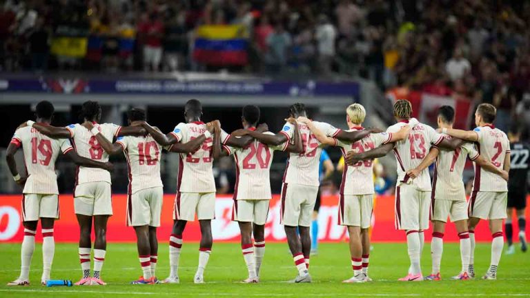 Canada players link arms before a shootout during a Copa America quarterfinal soccer match between Venezuela and Canada, Friday, July 5, 2024, in Arlington, Texas. (Julio Cortez/AP)