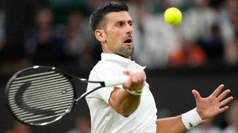 Novak Djokovic of Serbia plays a forehand return to Alexei Popyrin of Australia during their third round match at the Wimbledon tennis championships in London, Saturday, July 6, 2024. (Kirsty Wigglesworth/AP)