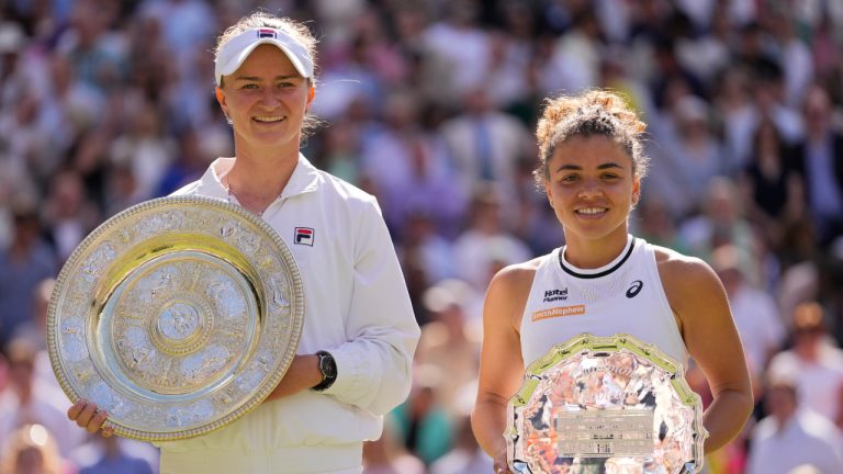 Barbora Krejcikova, left, of the Czech Republic holds her trophy after defeating Jasmine Paolini, right, of Italy in the women's singles final at the Wimbledon tennis championships in London, Saturday, July 13, 2024. (Alberto Pezzali/AP) 