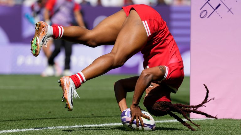 Canada's Charity Williams does a forward roll as she score a try during the women's Pool A Rugby Sevens match between Canada and China at the 2024 Summer Olympics, in the Stade de France, in Saint-Denis, France, Monday, July 29, 2024. (Tsvangirayi Mukwazhi/AP) 