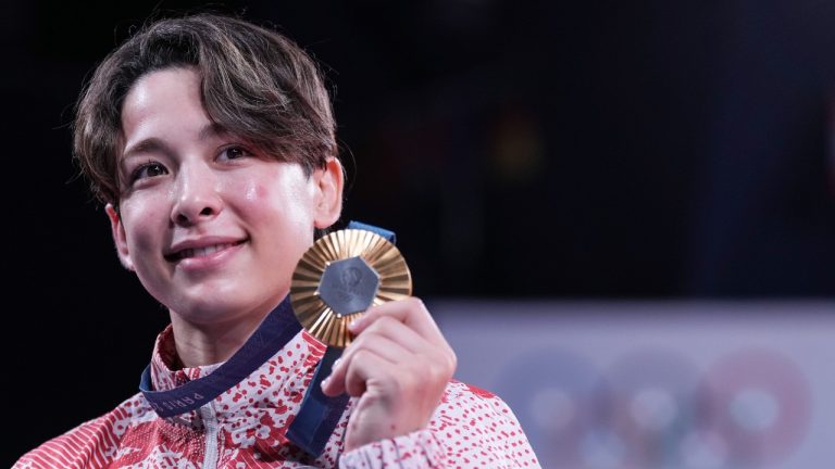 Canada's Christa Deguchi holds her gold medal after her win in the women's under-57 kg judo at the 2024 Summer Olympics in Paris, France on Monday, July 29, 2024. (CP)