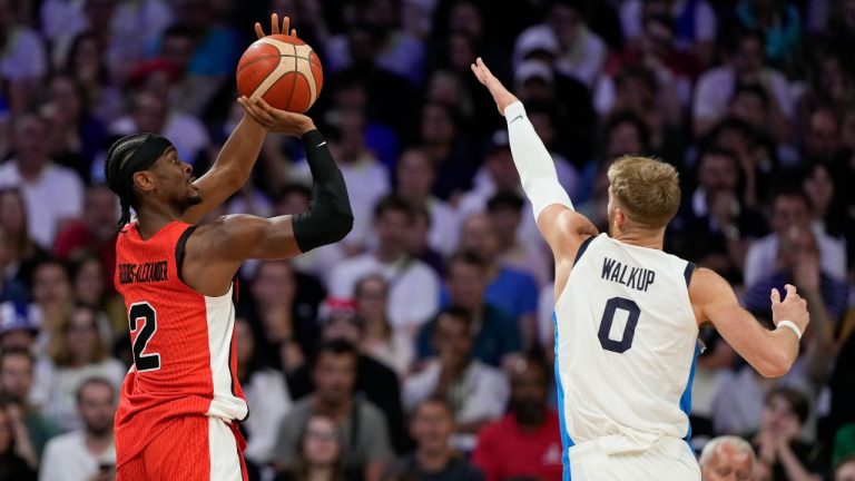 Shai Gilgeous-Alexander, of Canada, shoots over Thomas Walkup, of Greece, in a men's basketball game at the 2024 Summer Olympics, Saturday, July 27, 2024 in Villeneuve-d'Ascq, France. (AP Photo/Mark J. Terrill)