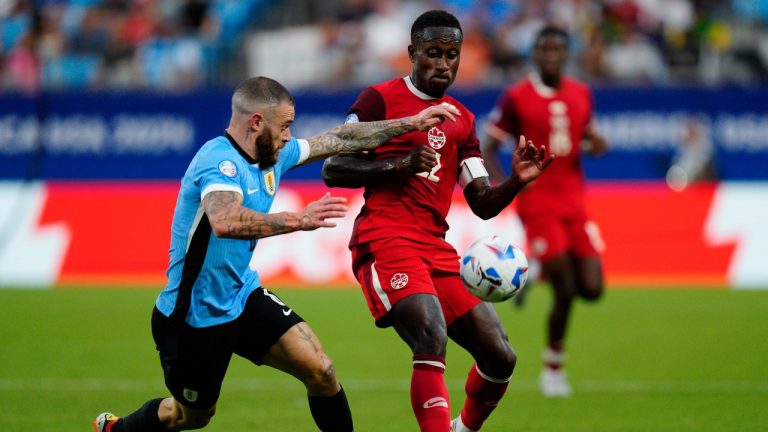 Canada's Richie Laryea, right, and Uruguay's Nahitan Nandez battle for the ball during the Copa America third place soccer match in Charlotte, N.C., Saturday, July 13, 2024. (AP/Jacob Kupferman)