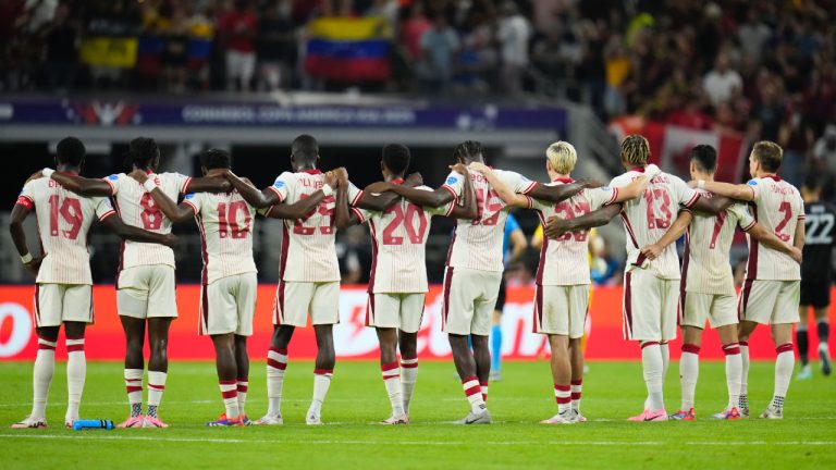 Canada players link arms before a shootout.(Julio Cortez/AP)