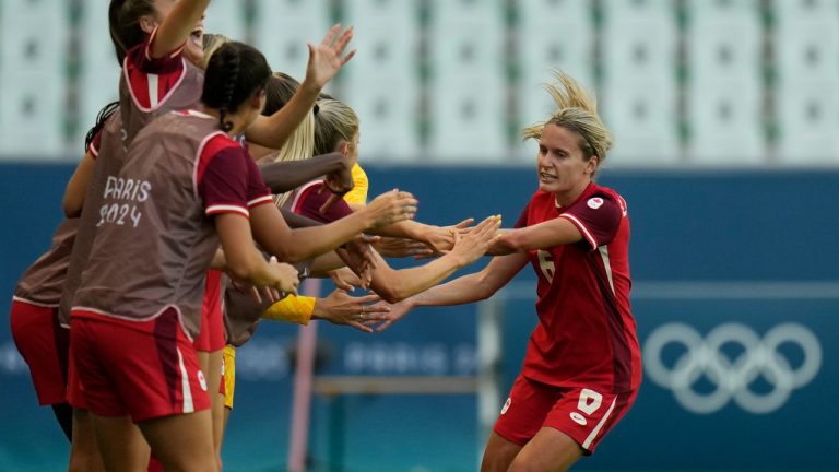 Canada's Cloe Lacasse, right, is congratulated after scoring her side's first goal during the women's Group A soccer match between Canada and New Zealand at Geoffroy-Guichard stadium during the 2024 Summer Olympics, Thursday, July 25, 2024, in Saint-Etienne, France. (AP/Silvia Izquierdo)