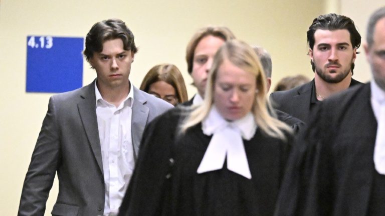 Former Victoriaville Tigres junior major hockey league players Nicolas Daigle, left, and Massimo Siciliano, right, follow defence lawyers as they leave the courtroom after pleading guilty on Wednesday, Oct. 11, 2023, in Quebec City. (Jacques Boissinot/CP)