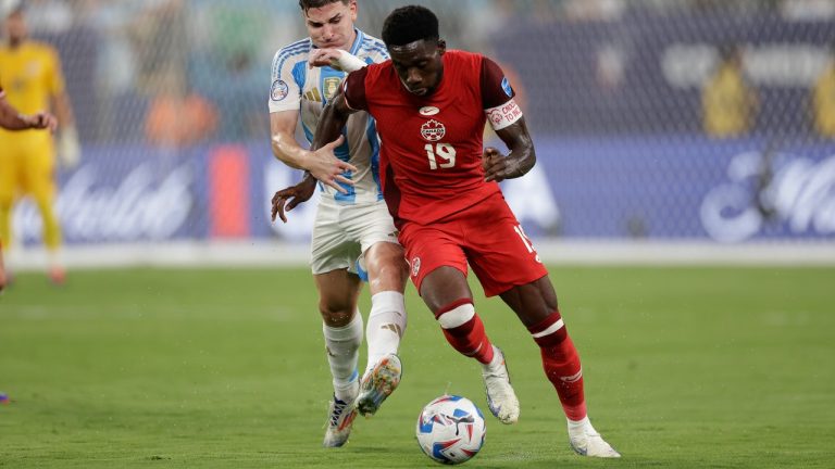 Argentina's Julian Alvarez, left, and Canada's Alphonso Davies vie for the ball during a Copa America semifinal soccer match in East Rutherford, N.J., Tuesday, July 9, 2024. (Adam Hunger/AP)