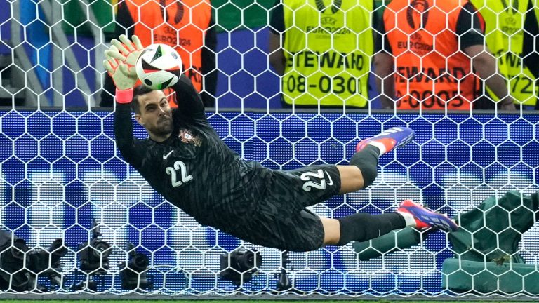 Portugal's goalkeeper Diogo Costa saves the ball during penalties of a round of sixteen match between Portugal and Slovenia at the Euro 2024 soccer tournament in Frankfurt, Germany, Monday, July 1, 2024. (Ebrahim Noroozi/AP)