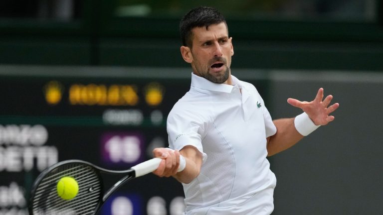 Novak Djokovic of Serbia plays a forehand return to Lorenzo Musetti of Italy during their semifinal match at the Wimbledon tennis championships in London, Friday, July 12, 2024. (AP/Kirsty Wigglesworth)