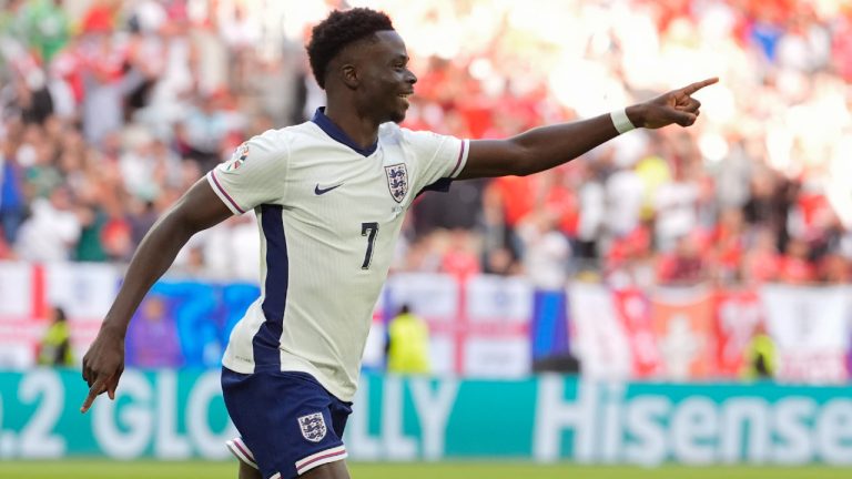 England's Bukayo Saka celebrates scoring his side's first goal during a quarterfinal match between England and Switzerland at the Euro 2024 soccer tournament in Duesseldorf, Germany, Saturday, July 6, 2024. (Martin Meissner/AP)