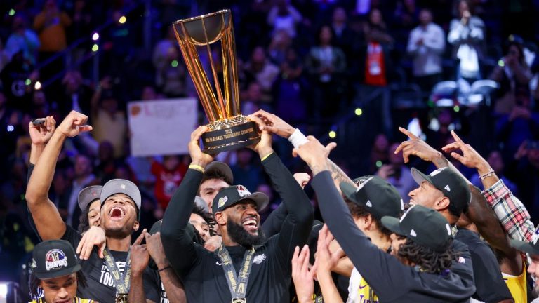 Los Angeles Lakers forward LeBron James lifts the the NBA Cup while celebrating with teammates after they defeated the Indiana Pacers 123-109 in the championship game in the NBA basketball In-Season Tournament on Saturday, Dec. 9, 2023, in Las Vegas. (Ian Maule/AP Photo)