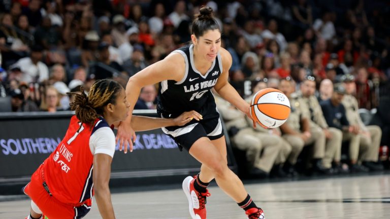 Las Vegas Aces guard Kelsey Plum (10) takes the ball past Washington Mystics guard Ariel Atkins (7) during the first half of an WNBA basketball game Thursday, July 4, 2024, in Las Vegas. (Steve Marcus/Las Vegas Sun via AP)