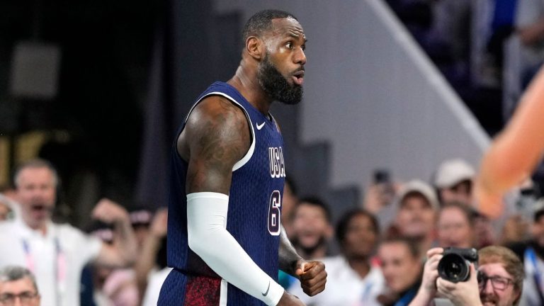 LeBron James, of the United States, celebrates after dunking in a men's basketball game against Serbia at the 2024 Summer Olympics, Sunday, July 28, 2024, in Villeneuve-d'Ascq, France. (Michael Conroy/AP Photo)