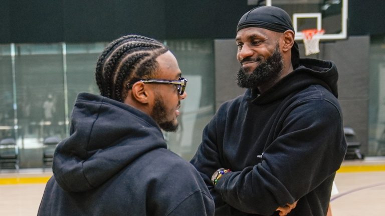 Los Angeles Lakers draft pick Bronny James, left, and his father, LeBron James, share a light moment as they arrive for the NBA basketball team's news conference in El Segundo, Calif., Tuesday, July 2, 2024 (Damian Dovarganes/AP)